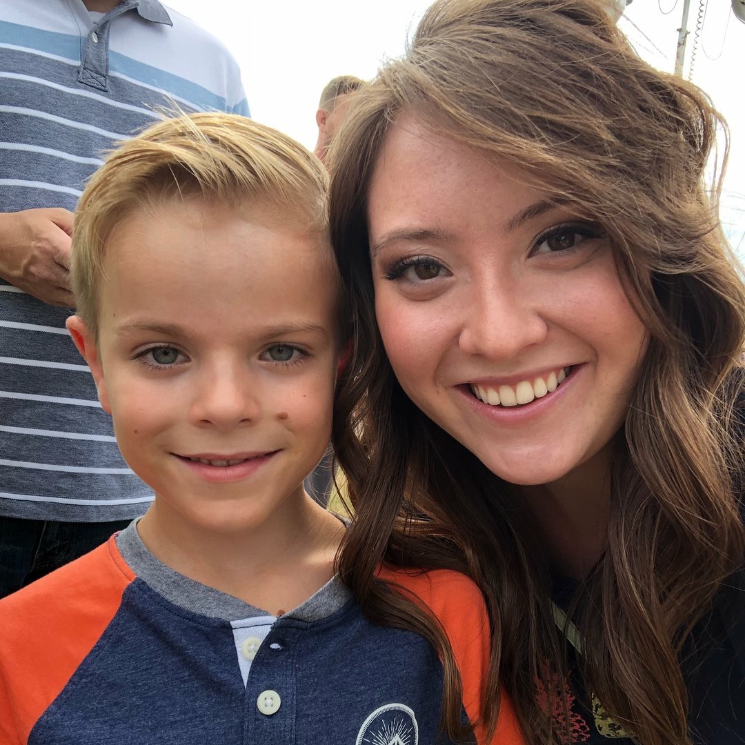 Kendra smiling beside a young boy